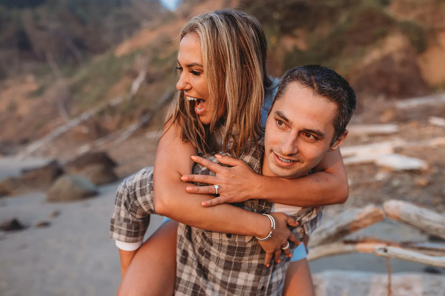 Olivia enjoying a playful moment with her fiancé at the coast